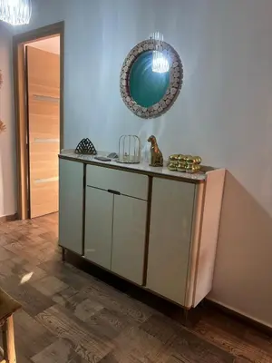 a room with a counter with a mirror on the wall at Cozy Apartement next to the airport in Deroua