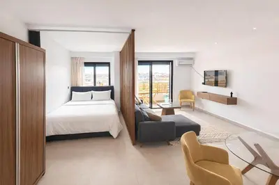 a bedroom with a bed and a living room at superbe loft au cœur de la ville in Casablanca