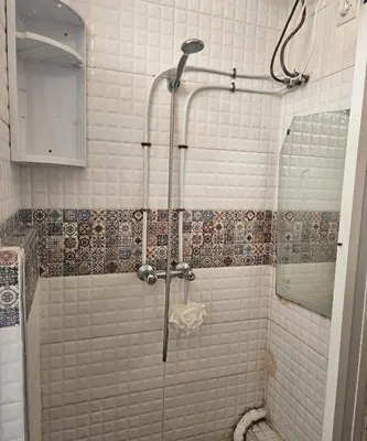 a shower with a glass door in a bathroom at Hassan in Rabat