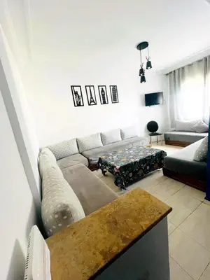 a living room with a couch and a table at lodgeocean in Rabat