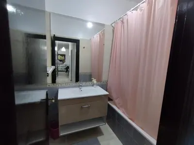 a bathroom with a sink and a large mirror at lodgeocean in Rabat