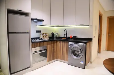 a kitchen with a washing machine and a washer at Socrates Prestige, quartier Les Princesses in Casablanca