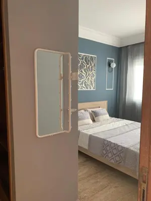 a bedroom with a bed and a mirror on the wall at Casablanca Stay in Casablanca