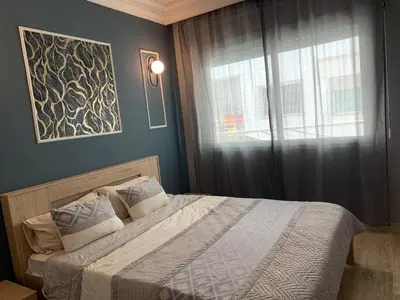 a bedroom with a large bed with a window at Casablanca Stay in Casablanca