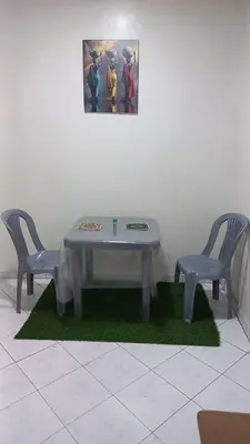 two chairs and a table and a picture on the wall at IDY HOME's in Casablanca