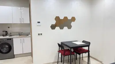 a kitchen with a table and chairs in a room at Centre Casablanca Studio karachi 24 in Casablanca