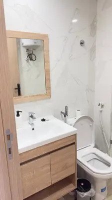 a white bathroom with a sink and a toilet at Centre Casablanca Studio karachi 24 in Casablanca