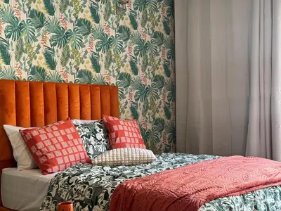 a bedroom with a bed with pillows on it at Elegant studio with large terrace in Rabat