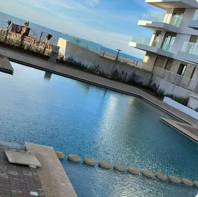a large swimming pool in front of a building at Appartement 1 chambre à rabat imkan in Rabat