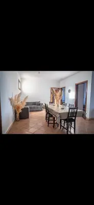 a living room with a table and chairs and a couch at Appartement spacieux à 15 minutes du stade Moulay Abdellah in Temara