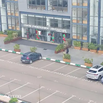an overhead view of a street with cars parked in front of a building at Hébergement en lit dans chambre et salle de bain partagées pour Hommes in Rabat