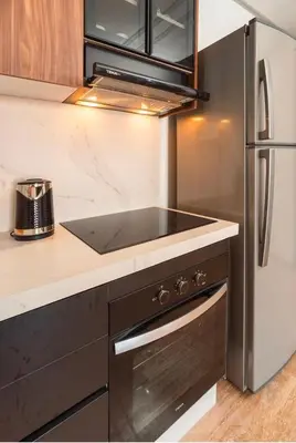a kitchen with a stove and a refrigerator at residence living housse in Casablanca