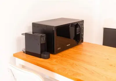 a microwave sitting on top of a wooden table at residence living housse in Casablanca