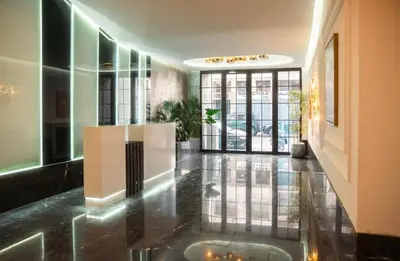 a hallway of a building with a lobby with glass doors at residence living housse in Casablanca