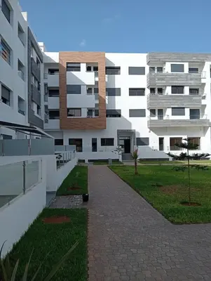a large white building with a pathway in front of it at A beautiful apartment for you in Rabat