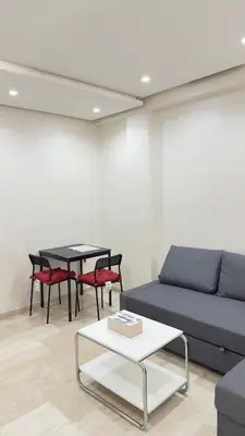 a living room with a couch and a table at Casablanca Center Studio Karachi 33 in Casablanca
