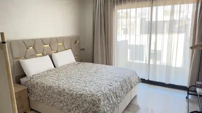 a bedroom with a bed and a large window at Casablanca Center Studio Karachi 33 in Casablanca