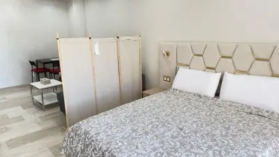 a bedroom with a large bed with white pillows at Casablanca Center Studio Karachi 33 in Casablanca