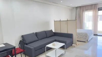 a living room with a couch and a bed at Casablanca Center Studio Karachi 33 in Casablanca