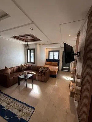 a living room with a couch and a tv in it at La garonne in Casablanca