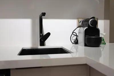 a kitchen counter with a sink and a camera at Premium Studio near Agdal Train Station in Rabat