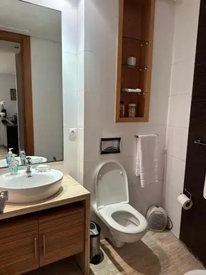 a bathroom with a white toilet and a sink at 9 Rue d'Alger Casablanca in Casablanca
