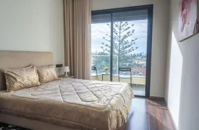 a bedroom with a large bed and a large window at Super Summit Apartments Le Phenix in Casablanca