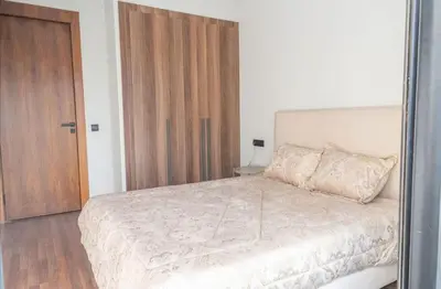 a bedroom with a large bed and a wooden door at Super Summit Apartments Le Phenix in Casablanca