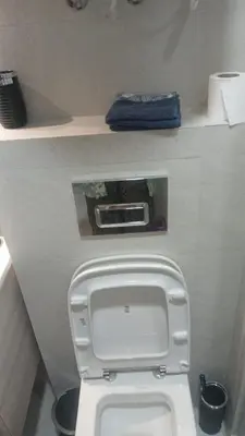 a bathroom with a white toilet with the lid up at Relaxing Studio Stay with Pool, Balcony & Smart TV in Aïn Harrouda