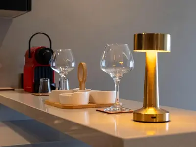 a table with two wine glasses and a lamp at Studio Joudia in Casablanca