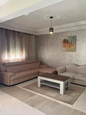 a living room with a couch and a coffee table at Appartement lumineux en plein coeur de harhoura in El Harhoura