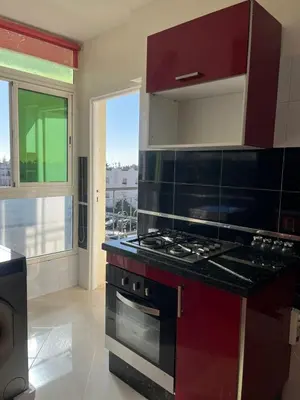 a kitchen with a stove top oven next to a window at Appartement lumineux en plein coeur de harhoura in El Harhoura