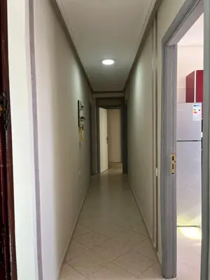 an empty hallway with a hallway leading into a room at Appartement lumineux en plein coeur de harhoura in El Harhoura