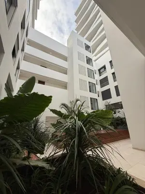 a white building with plants in front of it at Charming 1-bedroom apartment, Casablanca Finance City in Casablanca