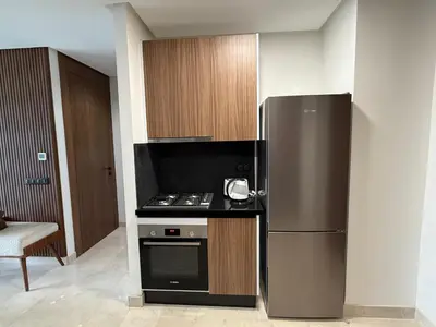 a kitchen with a stainless steel refrigerator and a stove at Charming 1-bedroom apartment, Casablanca Finance City in Casablanca