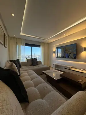 a living room with two couches and a flat screen tv at Agdal Gare View Apartment in Rabat