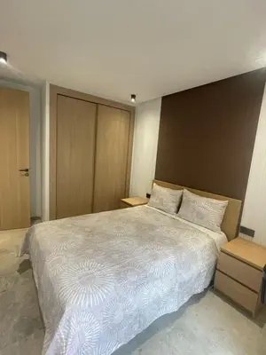 a bedroom with a large white bed with two pillows at Studio à louer in Casablanca
