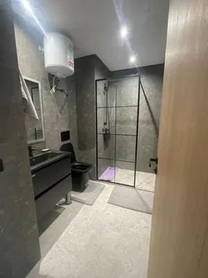 a bathroom with a shower and a toilet and a sink at Studio à louer in Casablanca