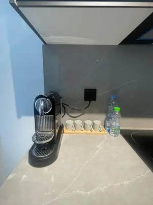 a kitchen counter with a hair dryer and bottles of water at Studio à louer in Casablanca