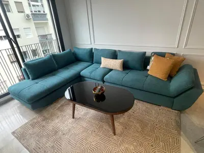 a blue couch in a living room with a coffee table at Studio à louer in Casablanca