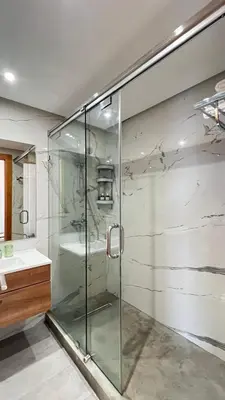 a glass shower in a bathroom with a sink at La Perle - Luxe & élégance Face à la gare Agdal in Rabat