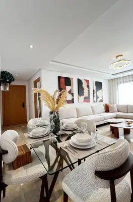 a living room with a glass table and chairs at La Perle - Luxe & élégance Face à la gare Agdal in Rabat