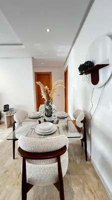 a dining room with a table and chairs at La Perle - Luxe & élégance Face à la gare Agdal in Rabat