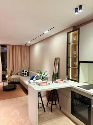 a kitchen and living room with a table and a couch at stylish studio located in centre of casablanca in Casablanca