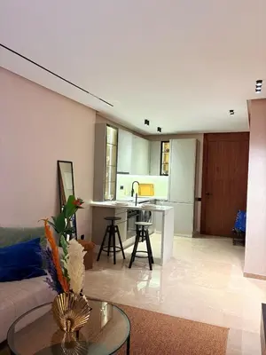 a living room and kitchen with a couch and a table at stylish studio located in centre of casablanca in Casablanca