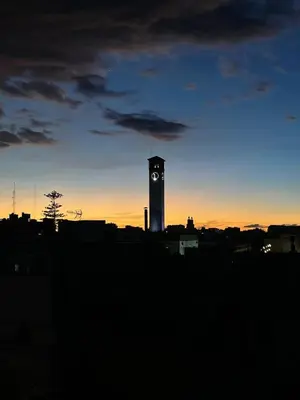 a clock tower in a city at sunset at Modern Chic Studio avec Terrace privée et Vue Sans Vis-a-vis et Parking privé in Casablanca