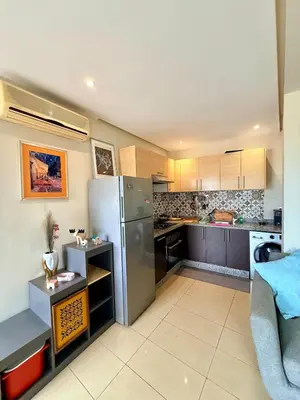 a kitchen with a stainless steel refrigerator and cabinets at Modern Chic Studio avec Terrace privée et Vue Sans Vis-a-vis et Parking privé in Casablanca