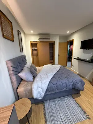 a bedroom with a bed and a couch at Modern Chic Studio avec Terrace privée et Vue Sans Vis-a-vis et Parking privé in Casablanca