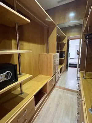 a large kitchen with wooden cabinets and shelves at Palais Elya in Rabat