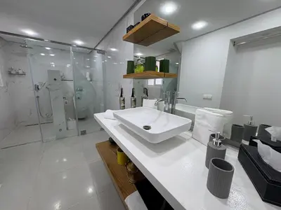 a white bathroom with a sink and a shower at Palais Elya in Rabat